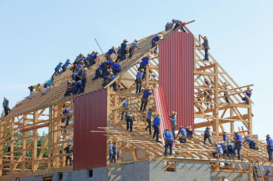 Large construction crew working on a timber structure, highlighting project complexity.