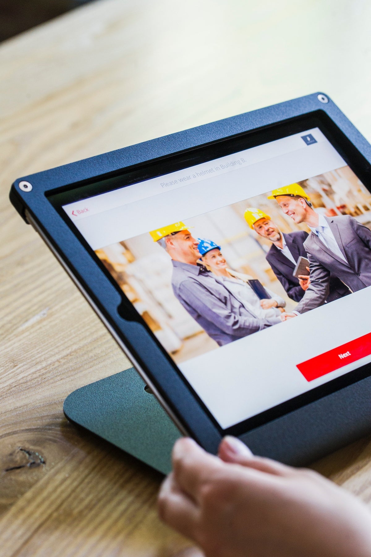 Close-up of a digital construction platform on a tablet displaying project team collaboration.