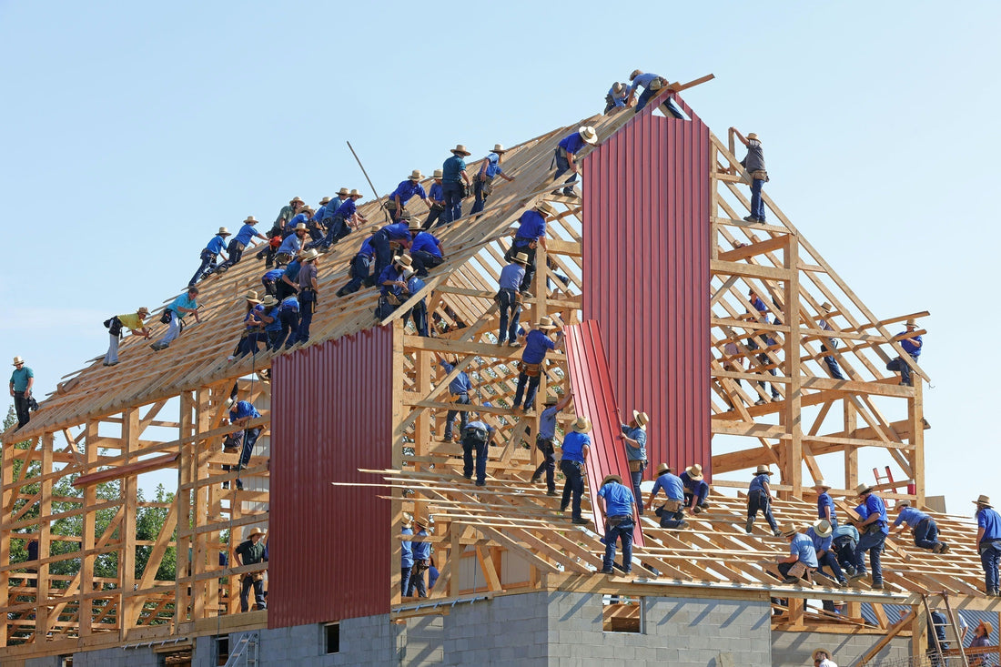 Large construction crew working on a timber structure, highlighting project complexity.